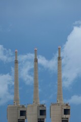 The three chimneys of the Sant Adrià de Besòs thermal power plant, with cloudy sky, Barcelona