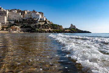 Fototapeta na wymiar View on sandy beach and sea water in medieval small touristic coastal town Sperlonga and sea shore, Latina, Italy