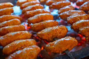 Turkish mixed grill meat, chicken wings, lamb, beef shashlik, kebab cooking on charcoal grill in restaurant