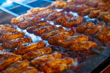 Turkish mixed grill meat, chicken wings, lamb, beef shashlik, kebab cooking on charcoal grill in restaurant