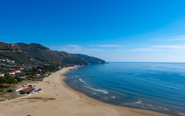 View on sandy beach from hilly medieval small touristic coastal town Sperlonga and sea shore, Latina, Italy
