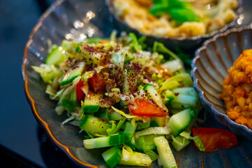 Vegetarian dishes, mezze in Turkish restaurant, bulgur pilaf, grilles eggplants and fresh vegetables salad
