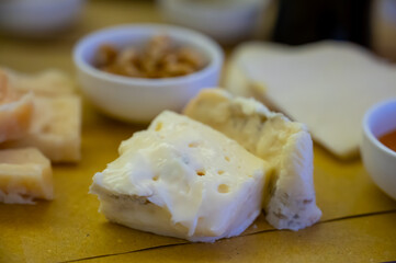 Cheese tasting, piece of italian blue cheeses gorgonzola dolce and picante with blue mold from north of Italy close up