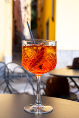 Aperol Spritz orange bitter long drink cocktail made with liqueur, prosecco sparkling wine, ice cubes and piece of orange, Milan, Italy