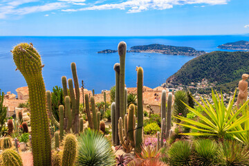 Scenic view of the Mediterranean coastline, medieval houses and exotic garden from the top of the medieval village of Eze village on the French Riviera - obrazy, fototapety, plakaty