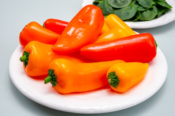 Fresh red, orange, and yellow sweet bell paprika close up