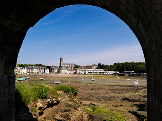 Port at low tide of Saint Servan who is a district of Saint Malo, seen through an arch of the Solidor tower fortress. Saint-Malo is a walled city in French Brittany