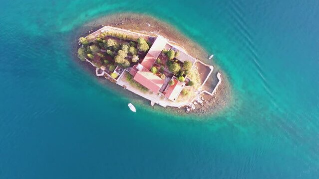 Aerial drone view of small island in the sea with church Lady of the Tickle church or Gospa od Skrpjela in Perast, Montenegro.