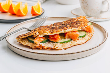 Oatmeal pancake stuffed with cream cheese, salmon and cucumber