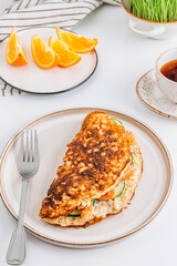Oatmeal pancake stuffed with cream cheese, salmon and cucumber