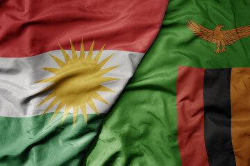 big waving national colorful flag of zambia and national flag of kurdistan.