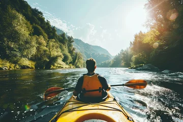 Foto op Plexiglas A man is kayaking down a mountain river. A man in a kayak, side view. A man on a mountain river is engaged in rafting © Vitalii Shkurko
