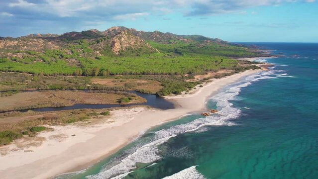 Aerial drone view on white sand Berchida beach of Sardegna. Warm turquoise sea and long beach on the Sardinia island.
