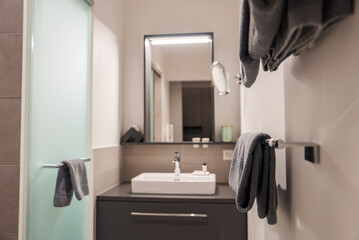 Luxury Engelberg resort bathroom with white sink, sleek cabinet, mirror light, plush towels,...