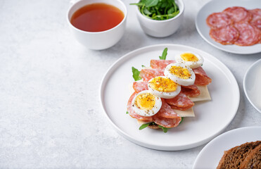 Salami sausages arugula cheese egg rye bread sandwich