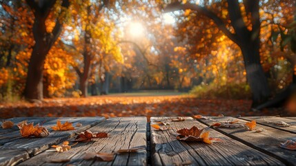 The surface of a wooden table framing a soft, blurred background of an autumnal forest park, the fall colors creating a warm and inviting atmosphere for seasonal product displays - obrazy, fototapety, plakaty