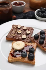 Fotobehang Different tasty toasts with nut butter and products on table, closeup © New Africa