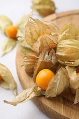 Fotobehang Ripe physalis fruits with calyxes on white table, closeup © New Africa