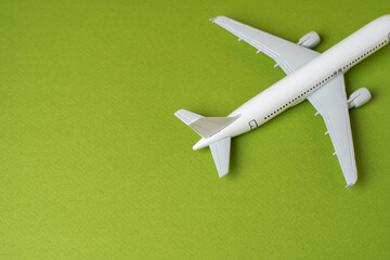 Fototapeta na wymiar Airlines plane on a green background. Planning your trips. Additional service at airports. Arrival and departure. Business and tourism. Airline. Booking flight tickets. Ecology and success concept.