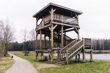 Lookout tower in National Park. Observatory by the lake. High wooden viewpoint.