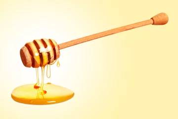 Rolgordijnen Natural honey dripping from dipper on yellow background © New Africa