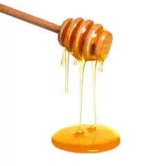 Rolgordijnen Natural honey dripping from dipper on white background © New Africa
