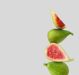 Stacked green figs on grey background, space for text