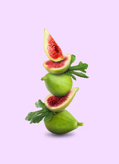 Stacked green figs and leaves on violet background