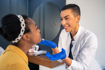 Female expert beautician preparing young woman for a skin treatment.