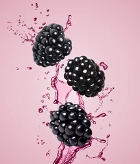 Rolgordijnen Fresh blackberries and juice in air on pink background © New Africa