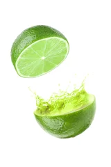 Rolgordijnen Lime with splashing juice on white background © New Africa