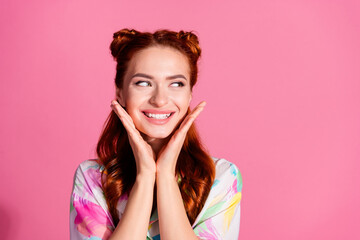 Obraz na płótnie Canvas Photo of nice girl with redhair tails dressed colorful blouse look empty space offer hands on cheeks isolated on pink color background
