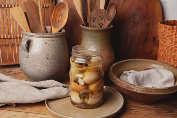 Hard-boiled chicken eggs are pickled in vinegar with spices (pepper, chili peppers, garlic, onion, and salt). The eggshells are crushed and the jar is refrigerated for about a week.