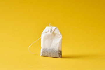 Tea bag on a yellow background.