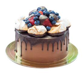 Chocolate cake decorated with strawberry dipped into melted chocolate, raspberry, blueberry and meringue. Isolated on plain background
