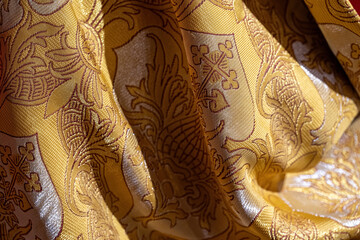 Pattern with a religious Christian motif on a gold dress.
