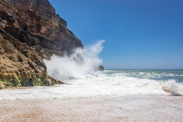 Rocks and waves on North Beach famous for giant waves in Nazare town on so called Silver Coast, Oeste region of Portugal