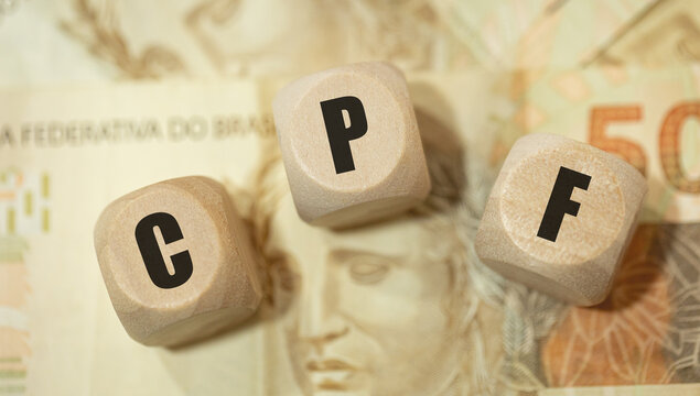 A sigla CPF para Cadastro de Pessoas F&iacute;sicas escrita em dados de madeira na linguagem Portugu&ecirc;s do Brasil.