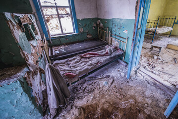 Beds in old cottage in abandoned Stechanka village in Chernobyl Exclusion Zone, Ukraine
