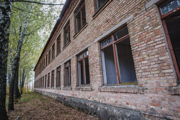 Fototapeta na wymiar Exterior of school in Illinci abandoned village in Chernobyl Exclusion Zone, Ukraine
