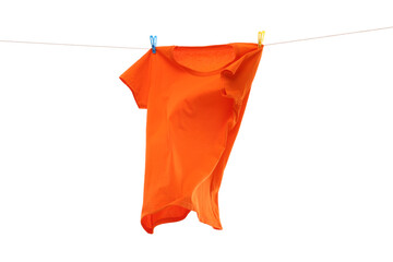 One orange t-shirt drying on washing line isolated on white