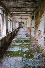 Fototapeta na wymiar Corridor in school in Illinci abandoned village in Chernobyl Exclusion Zone, Ukraine