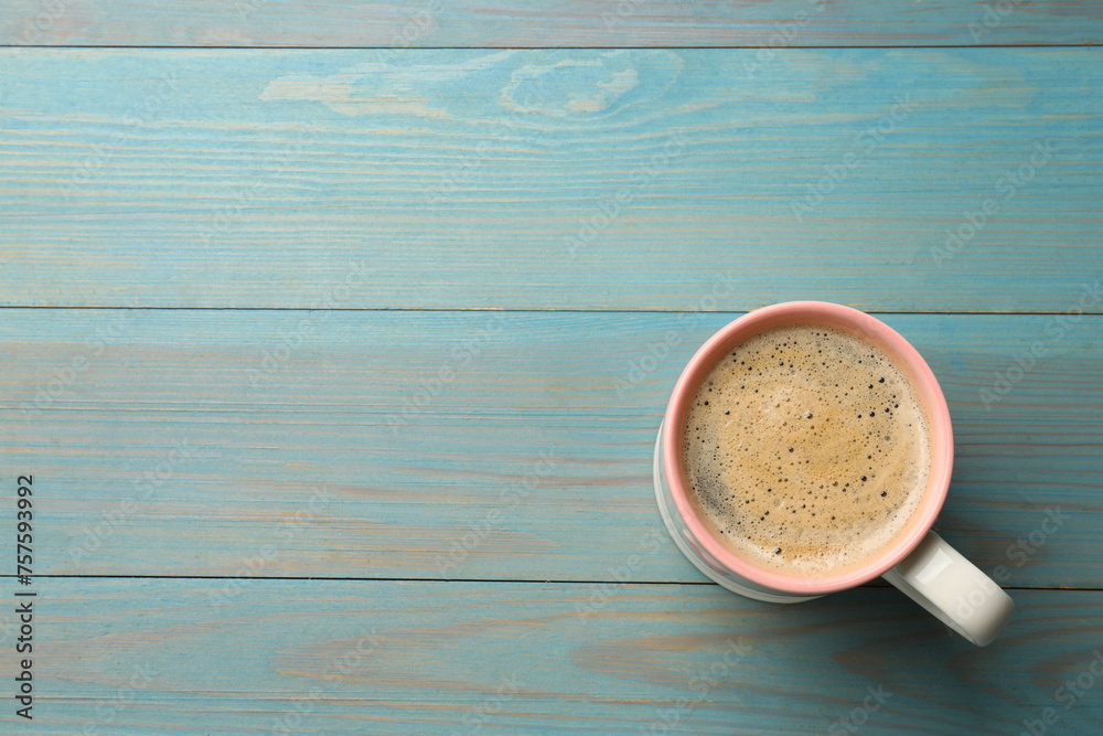 Canvas Prints Cup of aromatic coffee on light blue wooden table, top view. Space for text