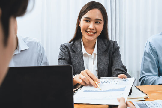 Asian analyst team use data science Fintech dashboard data paper to analyze financial report on meeting table. Data analysis for planning business strategy and marketing indication. Concord