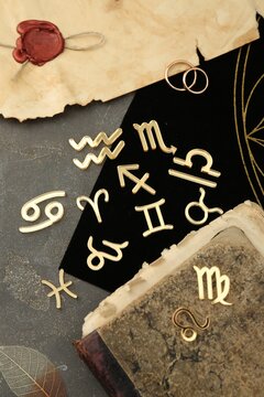 Flat lay composition with zodiac signs on grey textured table