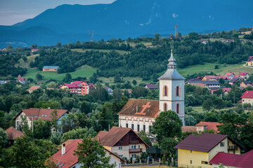 Aerial view with church of village of Bran commune area in Romania