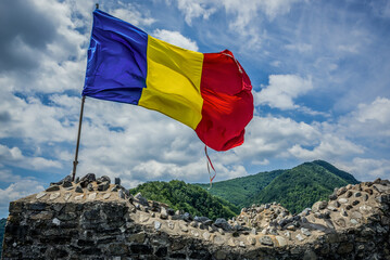 Romanian flag in ruined Poenari Castle on Mount Cetatea in Romania