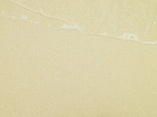 Sea water on sandy beach sand - nature background.