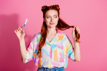 Portrait of confident woman wear print shirt look at foxy curl hold scissors making tail shorter isolated on pink color background