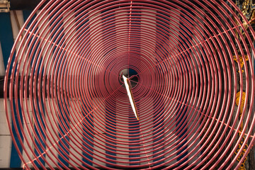 Spiral incense hang from the roof inside the temple